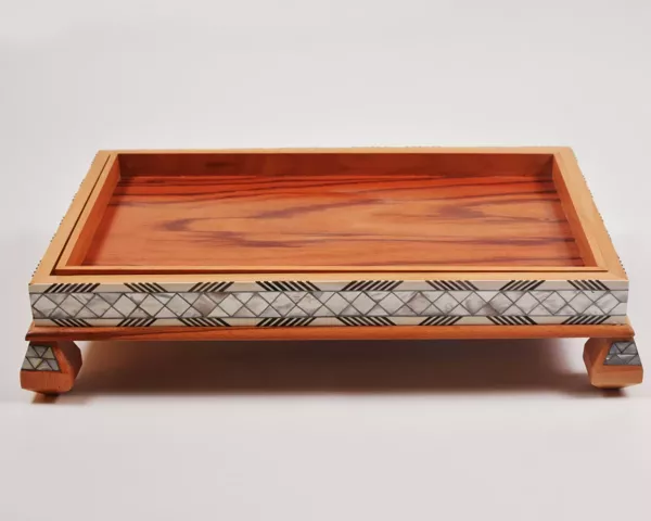 Large handcrafted wooden tray, carefully crafted and decorated with intricate mother-of-pearl inlays for an open buffet.