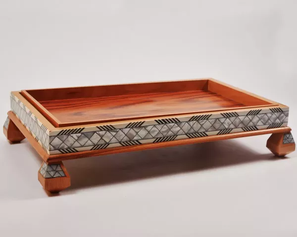 Large handcrafted wooden tray, carefully crafted and decorated with intricate mother-of-pearl inlays for an open buffet.