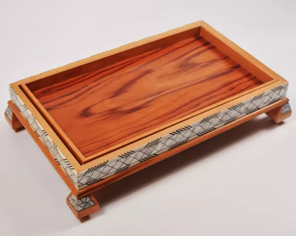 Large handcrafted wooden tray, carefully crafted and decorated with intricate mother-of-pearl inlays for an open buffet.