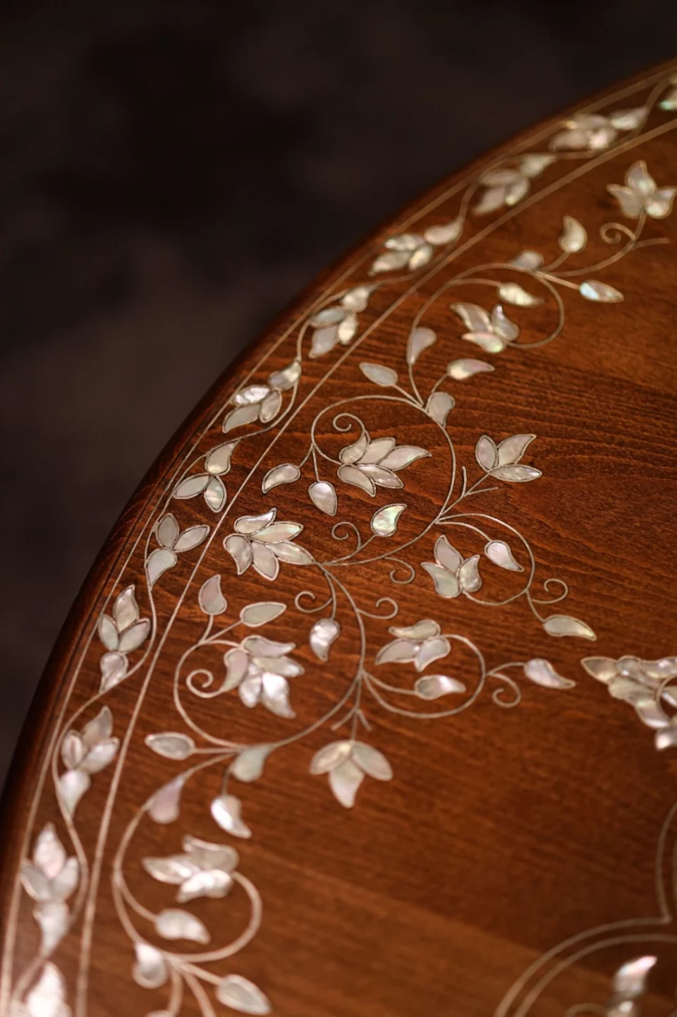 Handmade round wooden table inlaid with natural mother-of-pearl