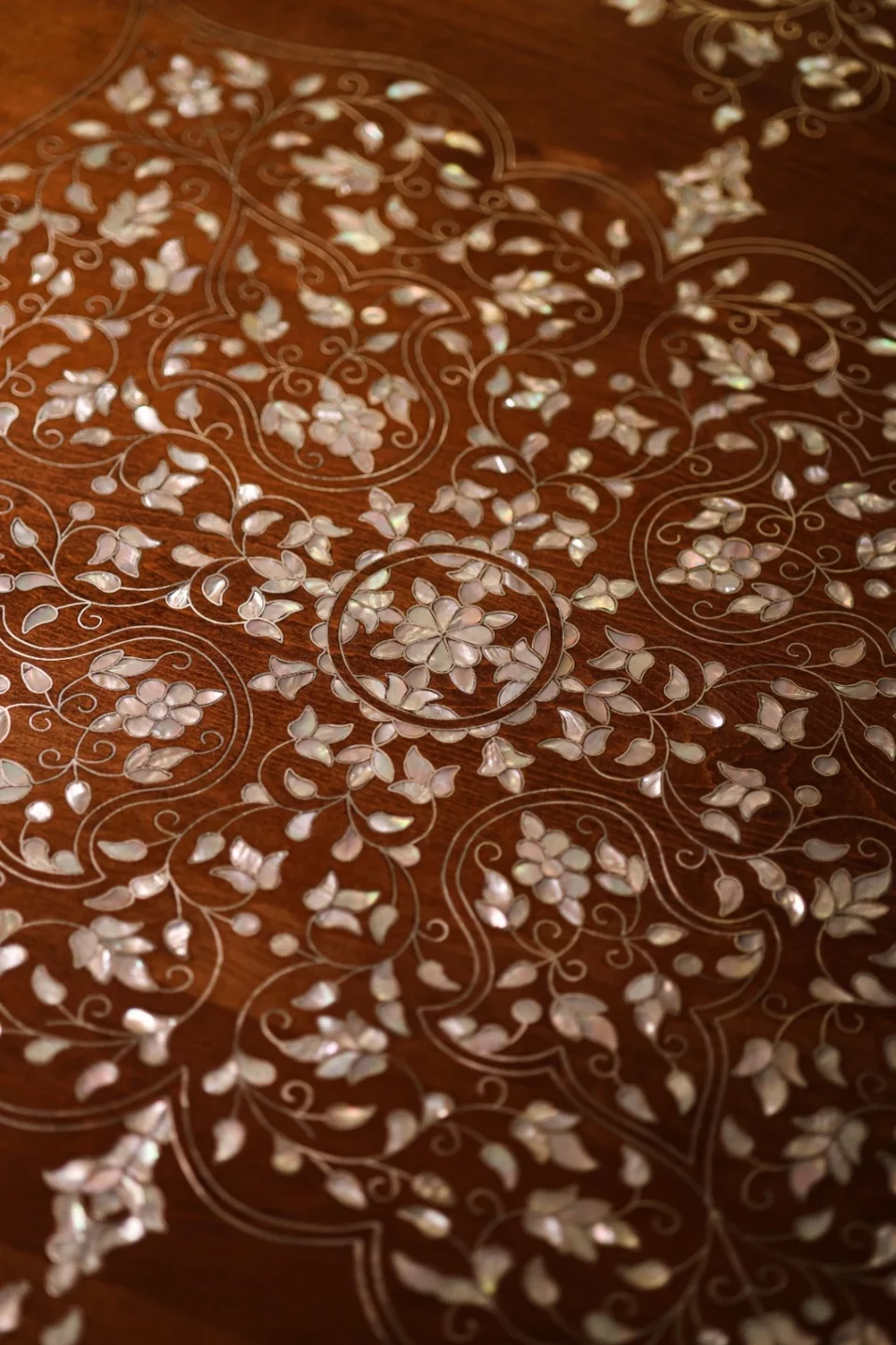 Handmade round wooden table inlaid with natural mother-of-pearl