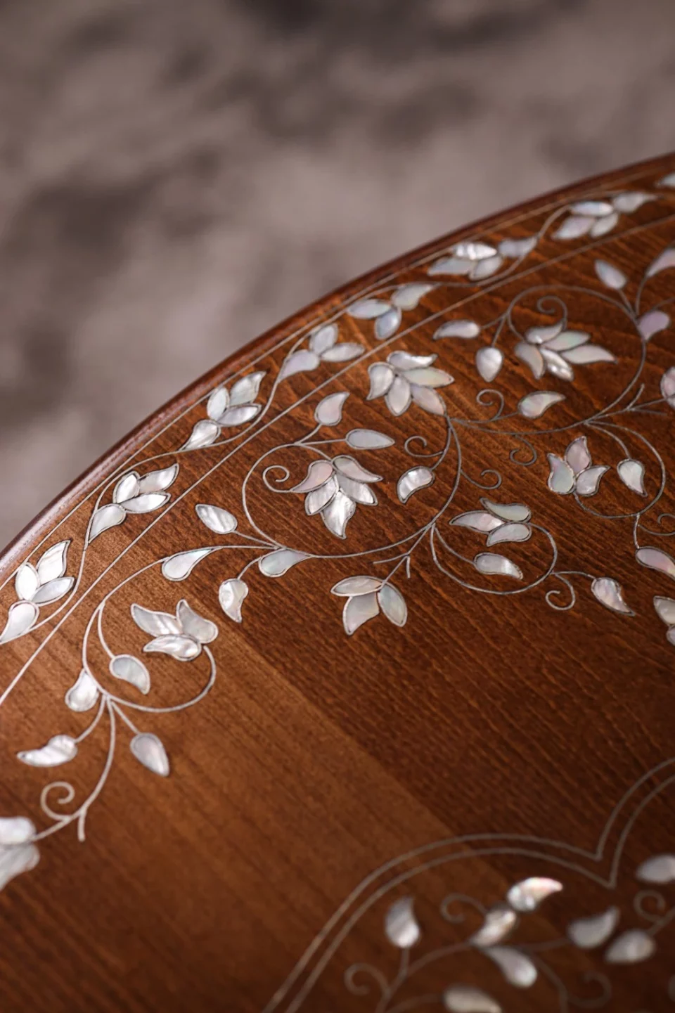 Handmade round wooden table inlaid with natural mother-of-pearl