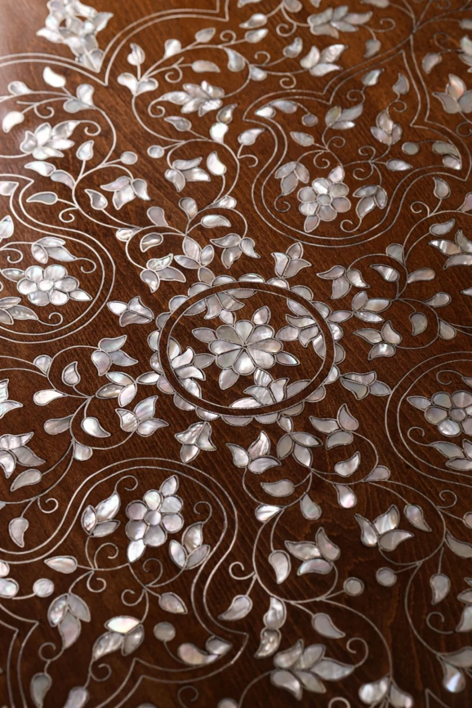 Handmade round wooden table inlaid with natural mother-of-pearl