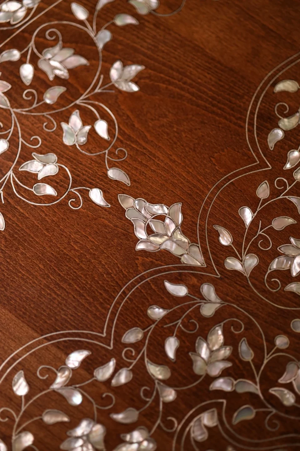 Handmade round wooden table inlaid with natural mother-of-pearl
